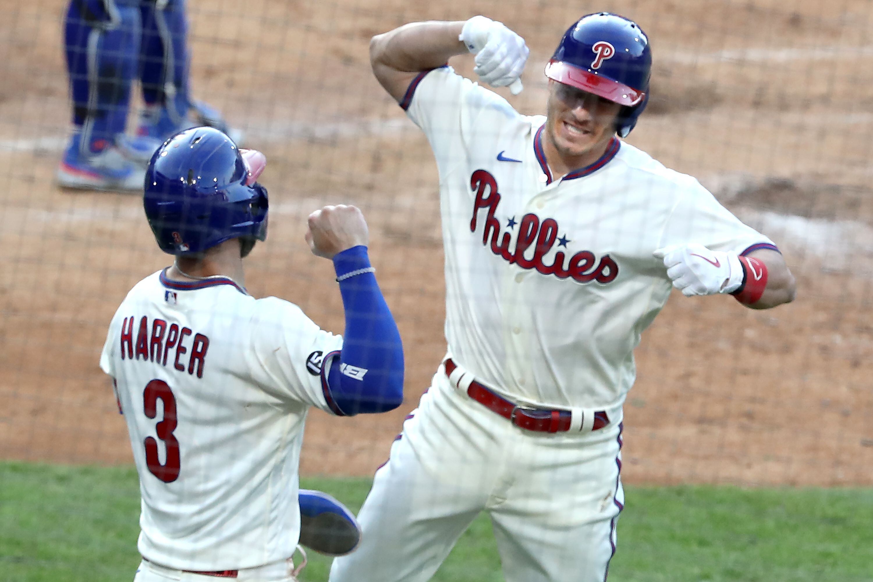 Philadelphia Phillies - Bryce Harper, Alec Bohm, J.T. Realmuto, and Rhys  Hoskins celebrating in the win line after the game. All are wearing the  cream Phillies uniform.