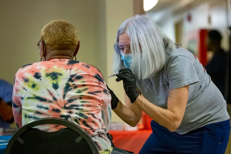 Barb Little, a Temple University Health System nurse, gives the Pfizer vaccine at a clinic at a Philadelphia Housing Authority site in March.