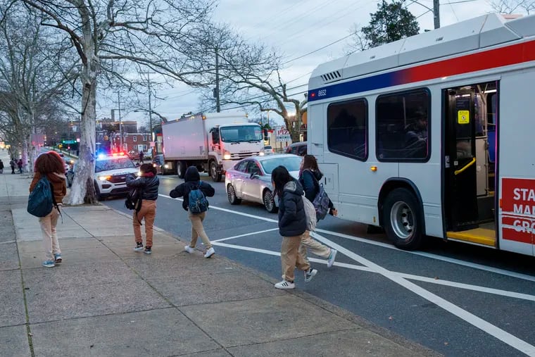 Students exit a SEPTA bus in March outside Northeast High School. As the school year starts again, Anne Dicker writes that fellow Philadelphians should commit to taking SEPTA more often.