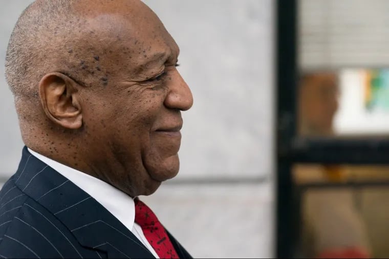 Bill Cosby receives assistance with his suit coat before walking into the Montgomery County Courthouse in Norristown on March 29, 2018.