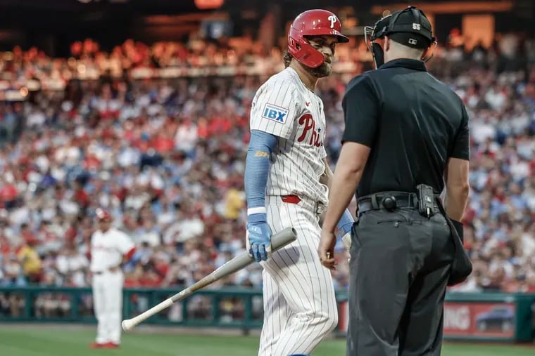 Bryce Harper looks over at home plate umpire Brennan Miller after being called out on strikes against the Marlins on Tuesday.