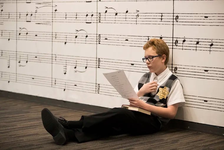 Blaise Slifer goes over the script before a performance. Members of the Keystone State Boychoir presented a special performance at what was then called the National Museum of American Jewish History on June 1, 2019, honoring Holocaust survivor and author Sidney Taussig.
