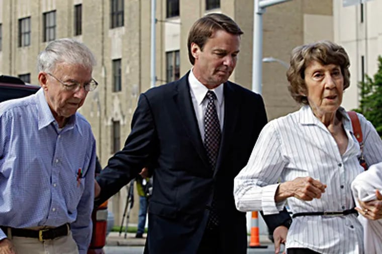 John Edwards leaves court in Greensboro, N.C., with his father, Wallace, and his mother, Bobbie. CHUCK BURTON / Associated Press