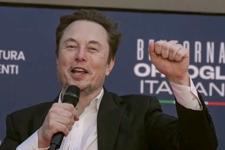 Tesla CEO Elon Musk waves as he arrives at the annual political festival Atreju, organized by the Giorgia Meloni's Brothers of Italy political party, in Rome, in December.