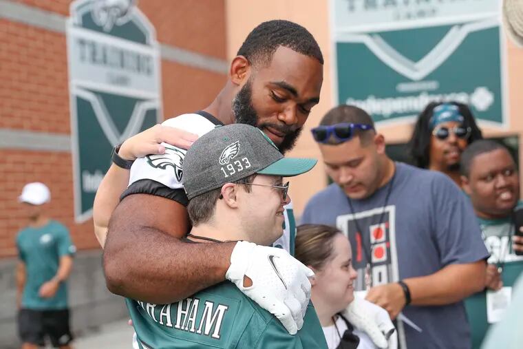 Brandon Graham greeting fans before the Eagles' first practice session of training camp Wednesday at the NovaCare Complex.