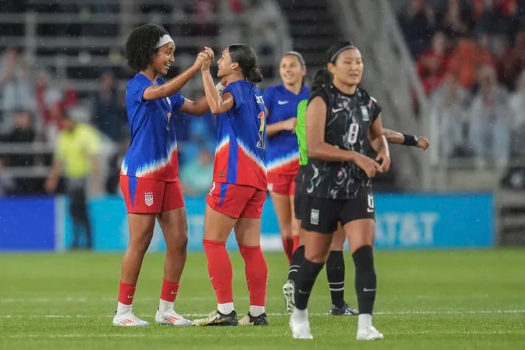 Lily Yohannes (left) celebrates with Sophia Smith (center) after scoring a goal in her U.S. women's soccer team debut.