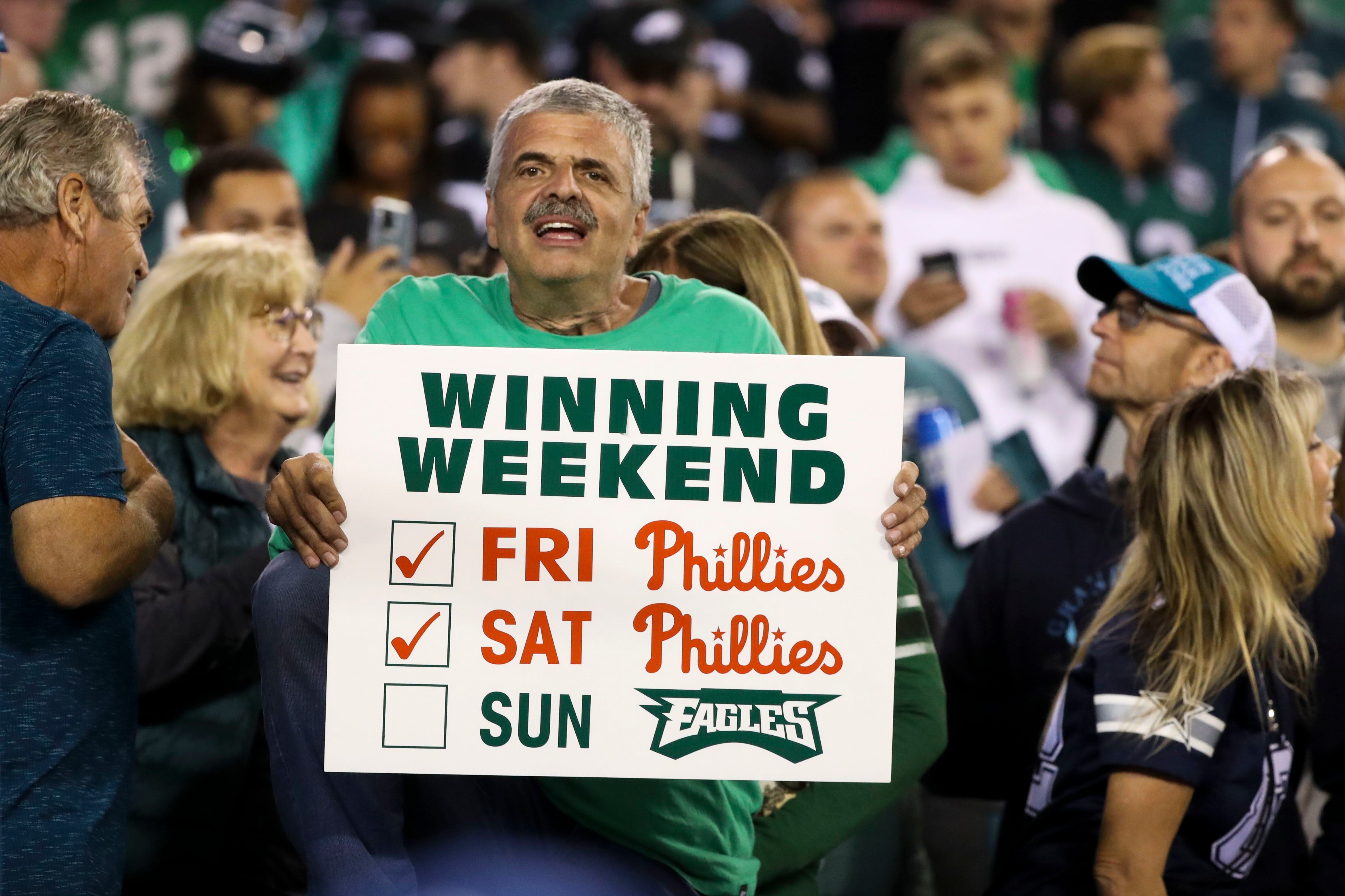 A young Eagles fan, completed with green painted face, protects himself  from rain during the first quarter of the Philadelphia Eagles-Dallas  Cowboys game in Philadelphia at Lincoln Financial Field, January 2, 2011.