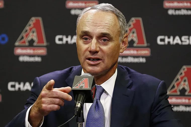 Rob Manfred, Commissioner of Major League Baseball, points to a reporter to ask a question during a news conference prior to an Arizona Diamondbacks baseball game against the San Diego Padres Tuesday, June 6, 2017, in Phoenix.