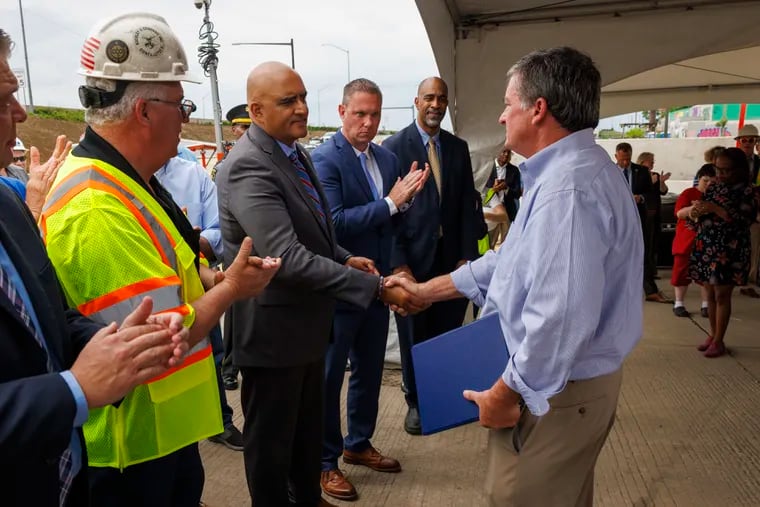 At right is Mike Carroll, Pennsylvania secretary of transportation, shaking hand of Shailen Bhatt, administrator of the Federal Highway Administration, celebrating the full rebuild of I-95 in Philadelphia after last year's highway collapse.