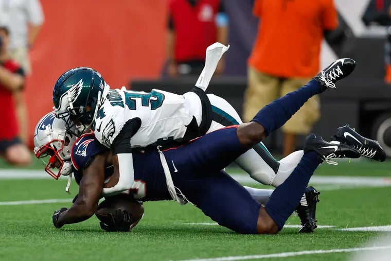 Former Eagles receiver Jalen Reagor is brought down by Eagles cornerback Isaiah Rodgers on Thursday.