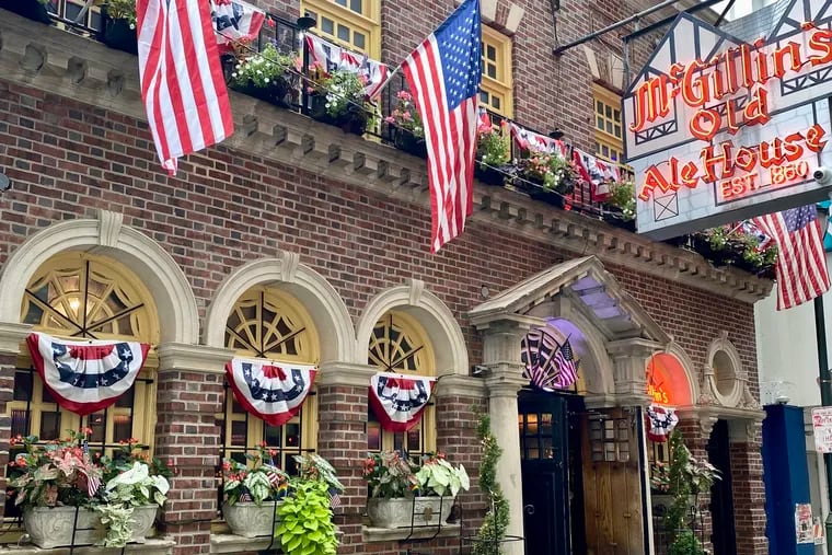 The exterior of McGillin's Olde Ale House sporting U.S. flags during the 2024 Olympic Games.