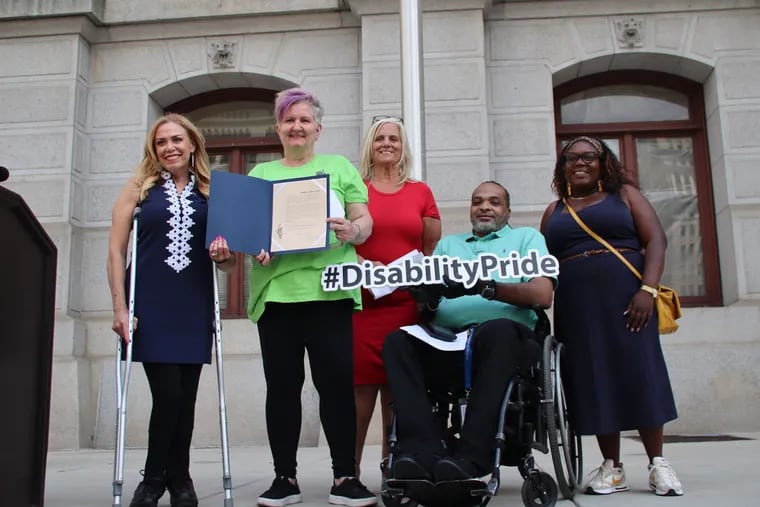 City Representative Sheila Hess, Vicki Landers, founder and executive director of Disability Pride PA, City Commissioners Chair Lisa Deeley, Chuck Horton, Disability Pride board president, and Councilmember Kendra Brooks pose at the Disability Pride flag raising outside City Hall on June 5th.
