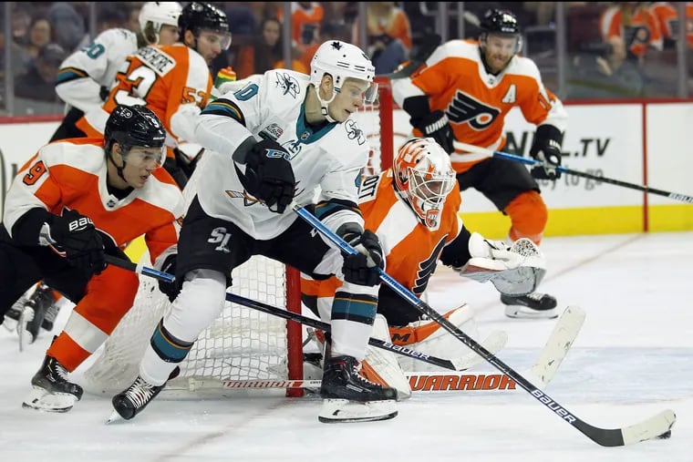 With the puck on his stick, San Jose's Antti Suomela attacks the goal asFlyers goalie Brian Elliott defends and defenseman Ivan Provorov (left) tries to break up the attempt. San Jose won that Oct. 9 game, 8-2, at the Wells Fargo Center.