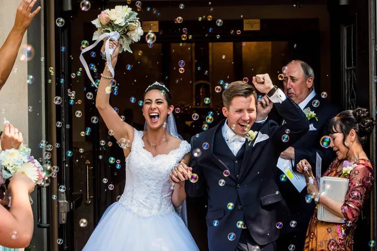 Elizabeth Walton and Noah Fox leave Annunciation of the Blessed Virgin Mary Church in Havertown after their wedding.