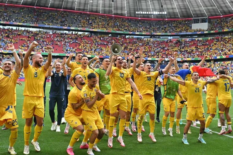 Romania's players acknowledge the public as they celebrate at the end of the UEFA Euro 2024 Group E football match between Romania and Ukraine at the Munich Football Arena in Munich on June 17, 2024. (Photo by MIGUEL MEDINA / AFP) (Photo by MIGUEL MEDINA/AFP via Getty Images)