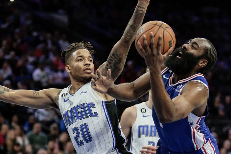 Sixers guard James Harden gets fouled by Magic guard Markelle Fultz during the 1st quarter at the Wells Fargo Center in Philadelphia, Monday,  January 30, 2023.