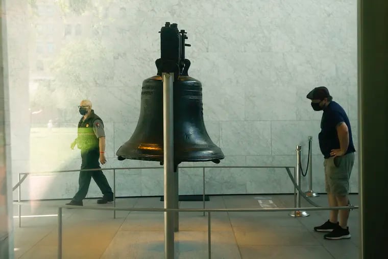 A visitor looks at the Liberty Bell at the Independence National Historical Park.