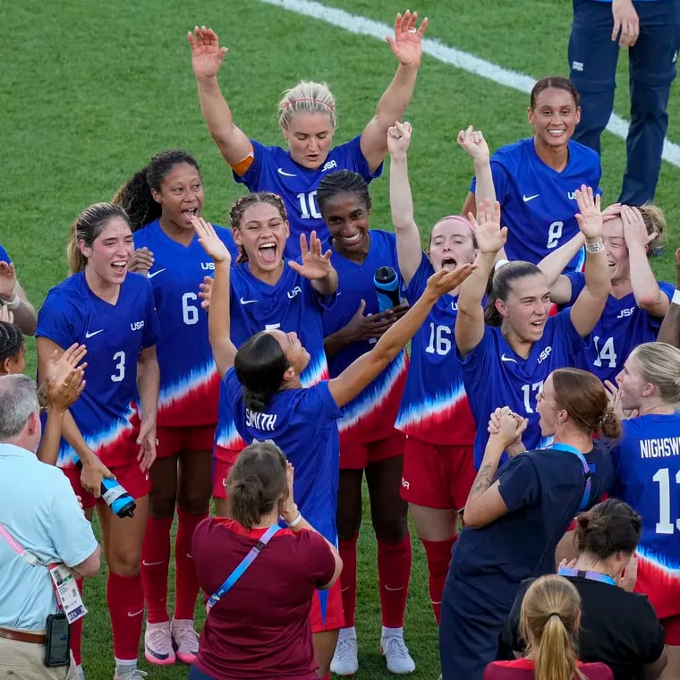 The U.S. women's soccer team celebrates after winning the gold medal against Brazil at the Paris Games.