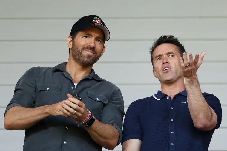 Ryan Reynolds, owner of Wrexham, and Rob McElhenney, actor and co-owner of Wrexham, react prior to the Vanarama National League Play-Off Semi Final match between Wrexham and Grimsby Town at Racecourse Ground on May 28, 2022, in Wrexham, Wales. (Lewis Storey/Getty Images/TNS)