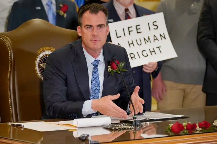 In this April 12, 2022, file photo, Oklahoma Gov. Kevin Stitt speaks after signing into law a bill making it a felony to perform an abortion, punishable by up to 10 years in prison in Oklahoma City.