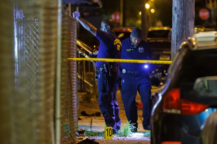 Officers with the Crime Scene Unit process evidence on the 1200 block of North Alden Street in West Philadelphia on Sunday, July 21.