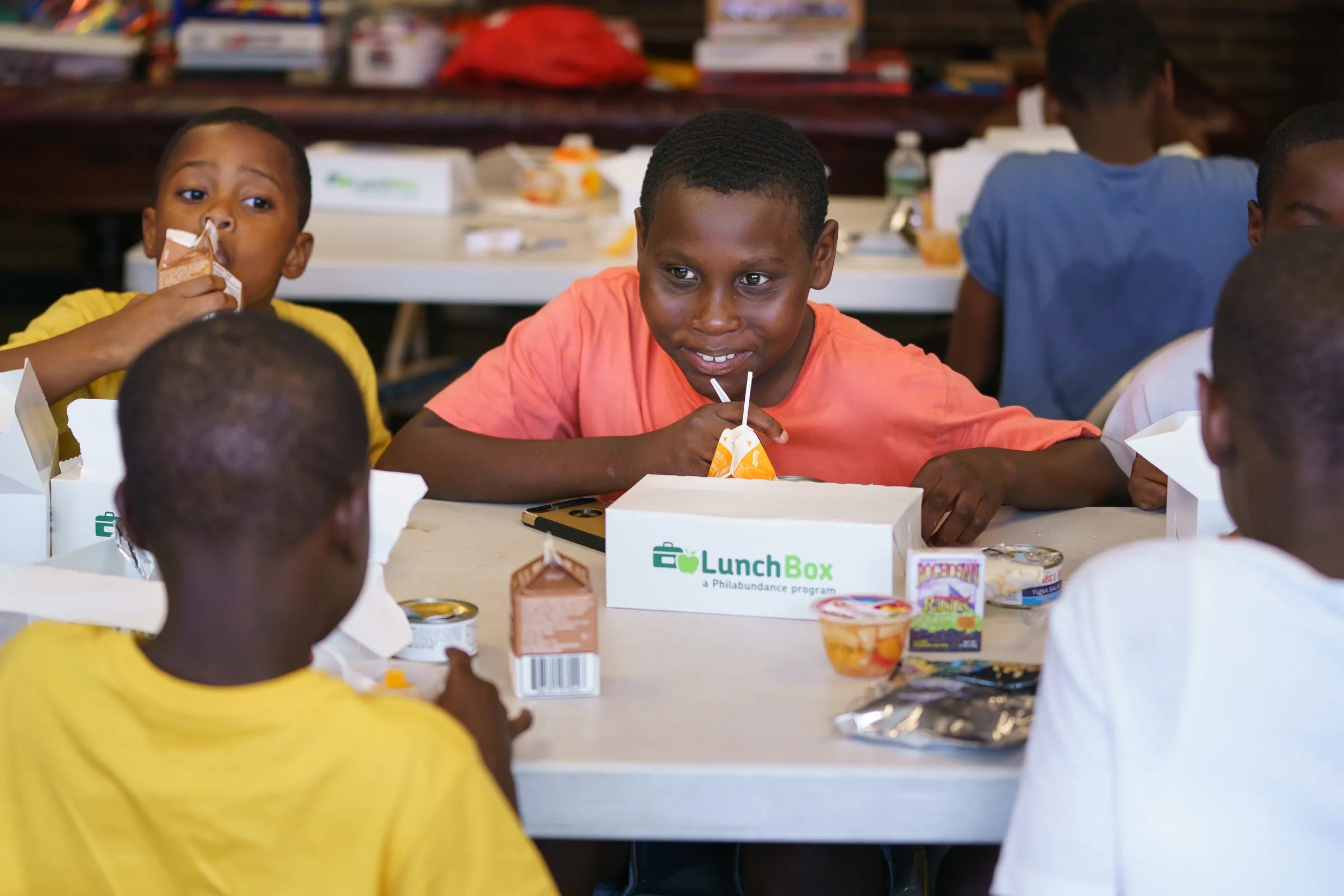 Sabre Washington, 7, left, Hytheem Fielder, 13, center, during a lunch provided by Philabundance at the Police Athletic League, in South Philadelphia, July 10, 2019. Philabundance provides free summer lunches through its Summer Lunchbox meal program at various locations throughout the city.
