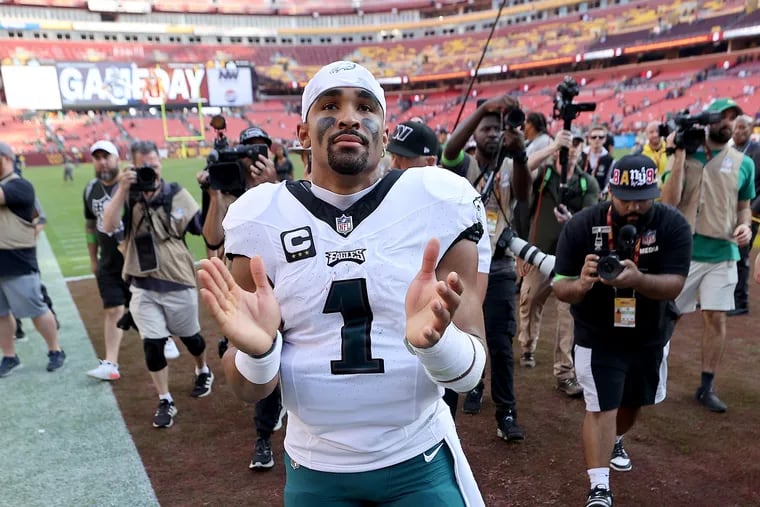 Jalen Hurts claps for the fans waiting by the team tunnel after the Eagles beat the Washington Commanders at FedEx Field in Landover, Md.