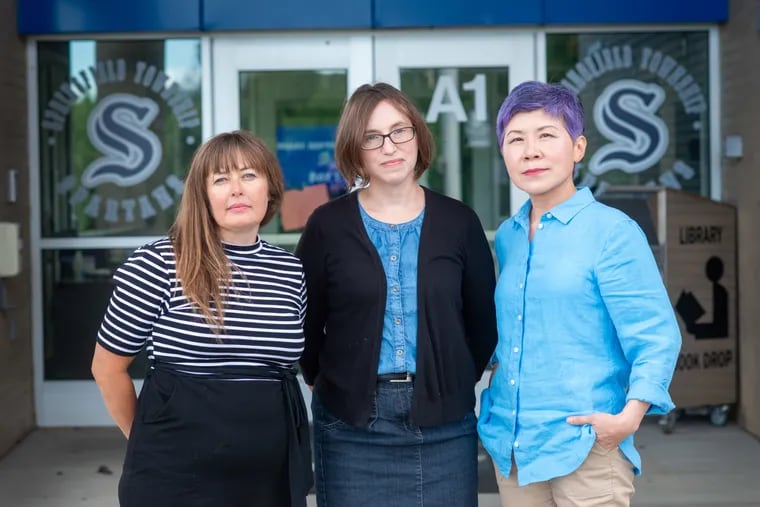 From left, Meredith McGlinchey, Karen Moore Schultz, and Sue-Im Lee, parents who banded together to push for restrictions on technology use in Springfield Township schools, pictured outside Springfield Township Middle School in Oreland.