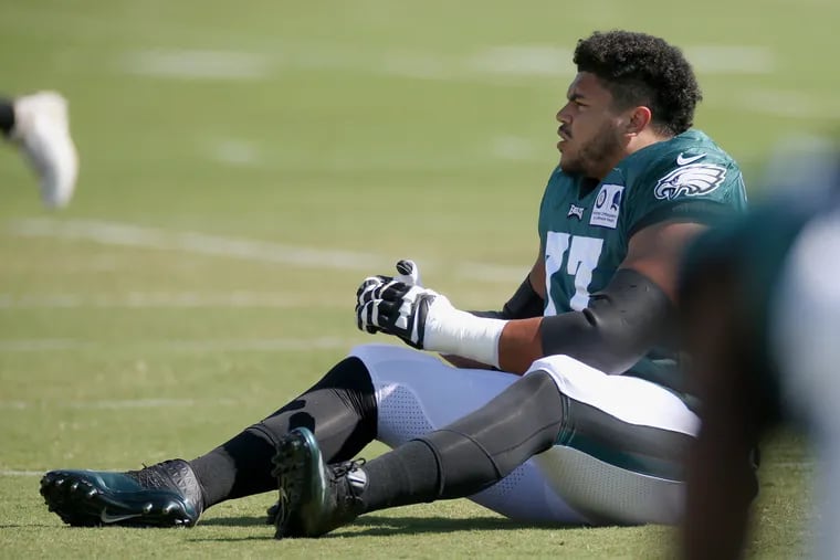 Eagles tackle Andre Dillard (77) stretches during training camp at the NovaCare Complex.