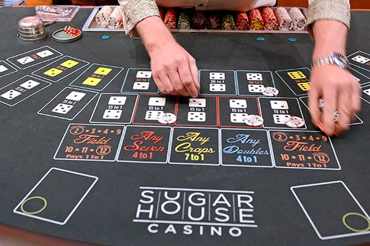 A casino delaer at work. SugarHouse Casino has gone to court in a bid to recoup more than $520,000 from 63 gamblers who have failed to repay markers - casino loans - issued in the last four years.  ( TOM GRALISH / Staff Photographer / File )