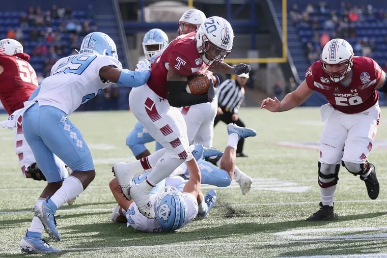 Temple running back Re'Mahn Davis (20) tumbles past North Carolina defensive back Storm Duck (29) into the end zone for a touchdown in the second quarter of the Military Bowl.