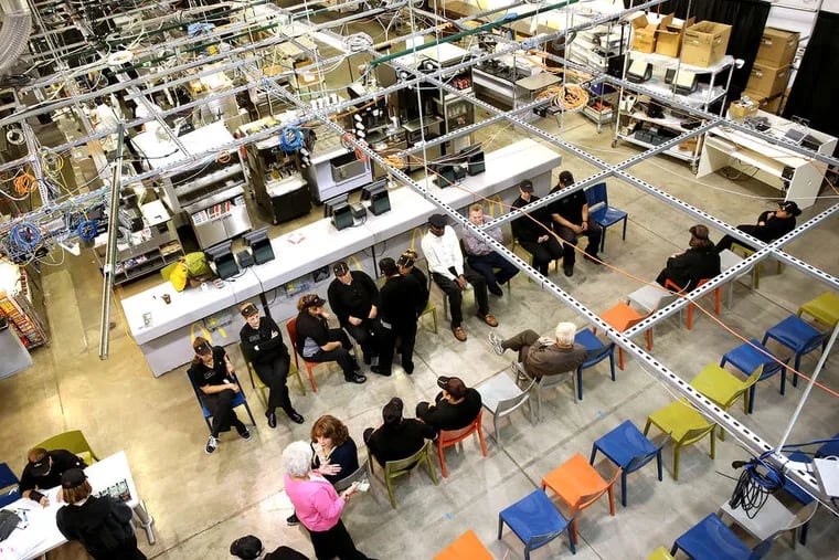 An overhead view of McDonald's Innovation Center in Romeoville, Ill., shows various setups, plenty of wiring and staff at the site. The fast-food operator tweaks routines and proposes ideas here that could quicken the operations at 34,000 restaurants worldwide.