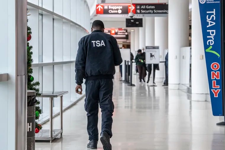 Travelers go through TSA security checkpoints on Dec. 21, 2021, at Philadelphia International Airport.