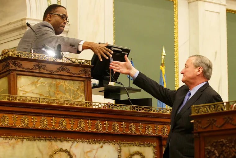 City Council President Darrell Clarke and Mayor Jim Kenney shake hands in City Council chambers.
