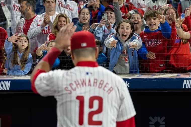 Phillies fans react to Kyle Schwarber as he walks off the field after a win earlier this season.