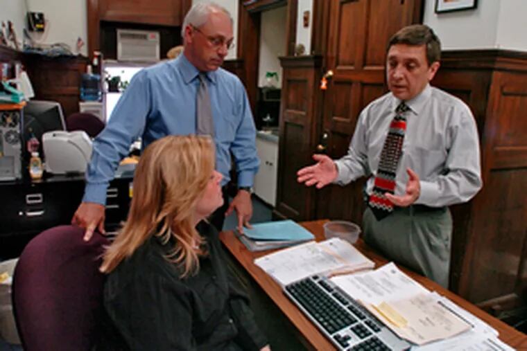 Councilman Frank DiCicco (right) talks with constituent-service aides Patricia Gilberti and Nick Schmanek in his City Hall office.
