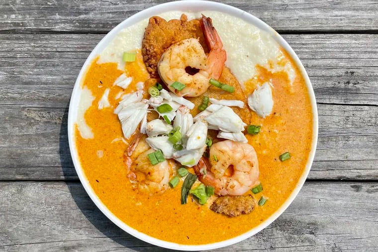 The Delta Dynasty from FoodChasers' Kitchen in Elkins Park is a bowl of cheesy grits topped with fried catfish, grilled shrimp, jumbo lump crab, and garlic butter sauce.