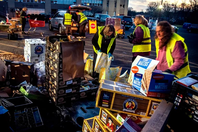 Volunteers distribute food items at the drive-through Martha’s Choice Marketplace in Norristown.