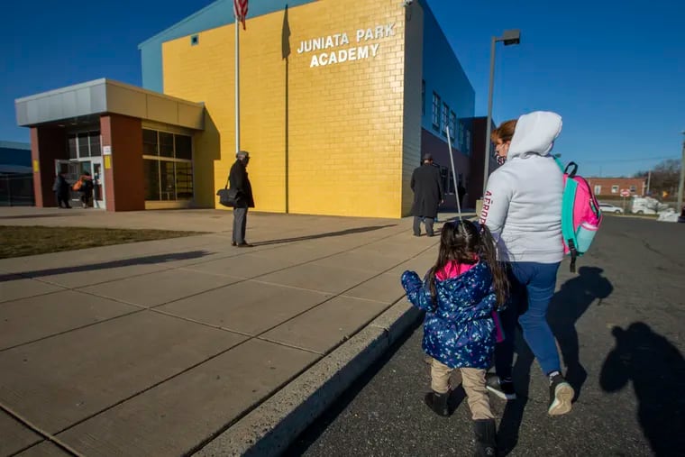 A woman walks her daughter to first day of Kindergarten at Juniata Park Academy on March 8.