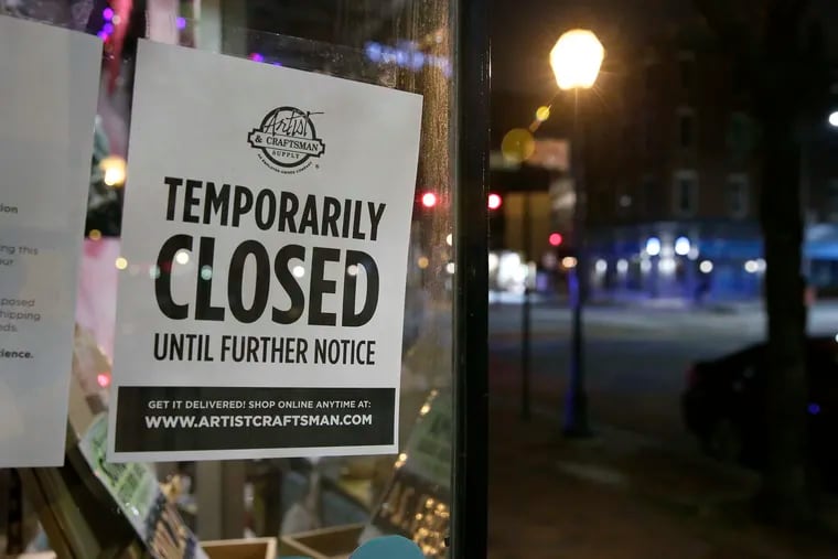 A sign in the window of the Artist and Craftsman Supply in Philadelphia alerts folks that they are closed until further notice.