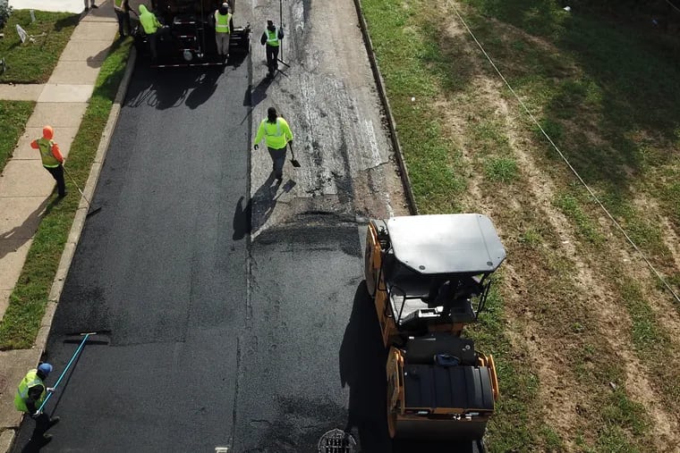 The city's street paving crews lay down a new surface on Benton Street near Bustleton Avenue as part of the street paving initiative in Philadelphia, Monday, October 16, 2018.