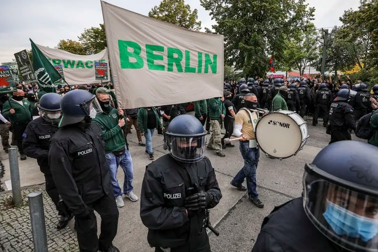 Supporters of the far-right Third Way (Der Dritte Weg) neo-Nazi political party march on the 30th anniversary of German reunification in Berlin's Hohenschoenhausen district on Saturday, Oct. 3, 2020. Several radical groups, including the Third Way as well as coronavirus skeptics preaching the overthrow of the German government, are taking to the streets in Berlin. The Third Way has been active since 2013 and is an offshoot of the mostly defunct far-right NPD (National Democratic Party of Germany).