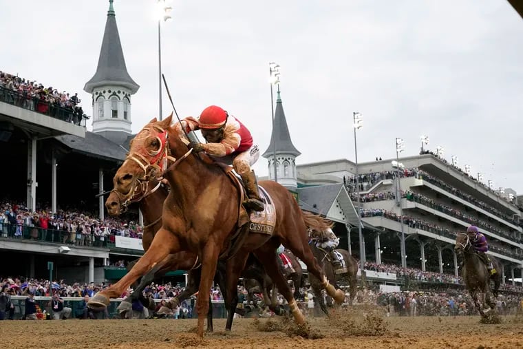 Rich Strike, with Sonny Leon aboard, crosses the finish line to win the 148th running of the Kentucky Derby at Churchill Downs on May 7, 2022.