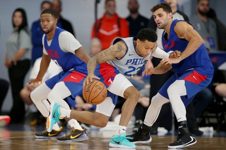 Sixers coach Brett Brown is keeping Raul Neto (right) and Trey Burke (center) engaged while trying to find the best rotation.