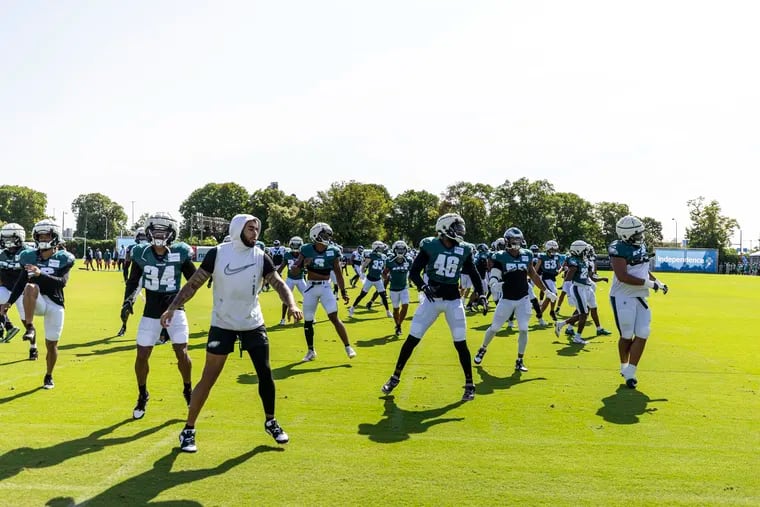 The Eagles warm up Wednesday at the start of practice at the NovaCare Complex.