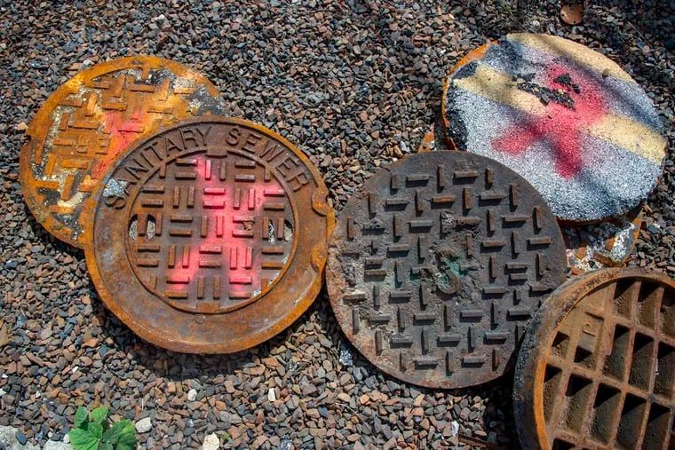 Old and damaged manhole covers at an area sewer plant.