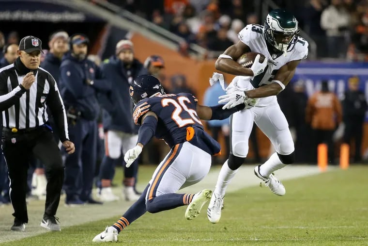 Nelson Agholor (13) evading a tackle by Bears safety Deon Bush (26) during the teams' playoff game in January.