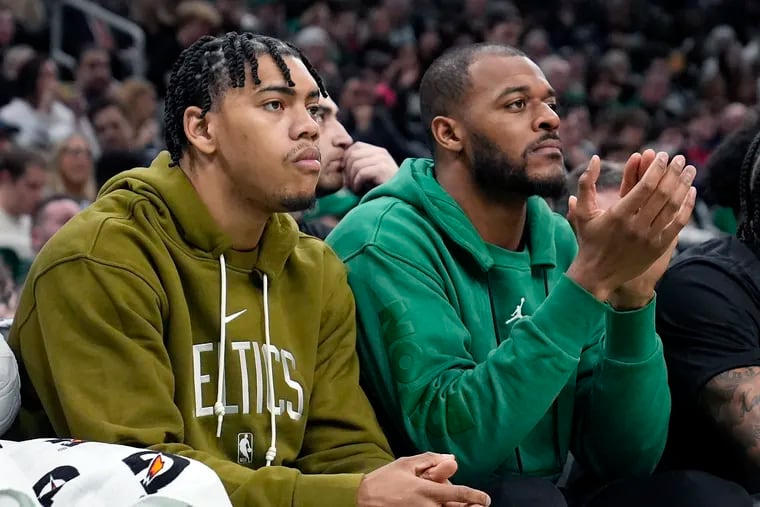 Boston Celtics' Xavier Tillman, right, and Jaden Springer sit on the bench during the first half of an NBA basketball game against the Washington Wizards, Friday, Feb. 9, 2024, in Boston. (AP Photo/Michael Dwyer)