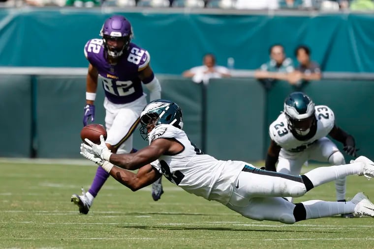 Eagles linebacker Oren Burks dives for the football in the third quarter. He didn't intercept the pass but finished with seven tackles.