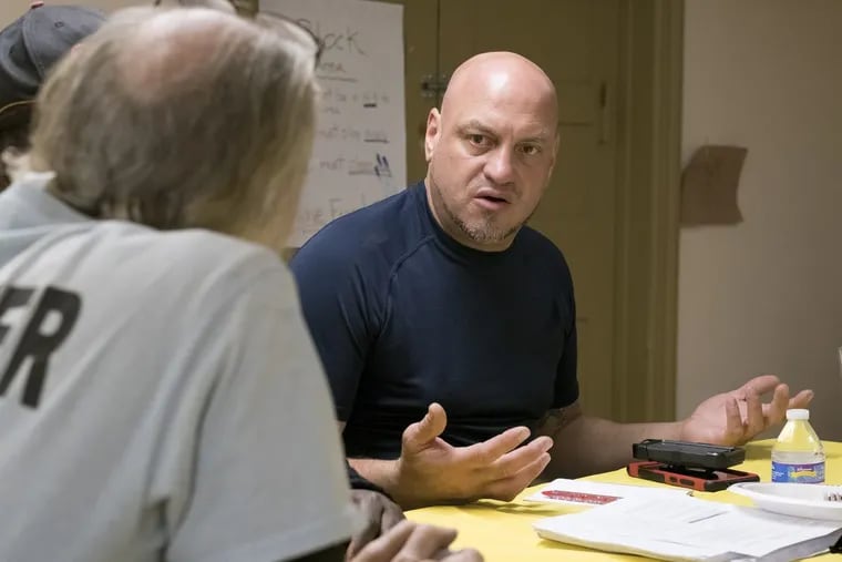 Elvis Rosado, a member of Prevention Post Philadelphia, talks with Dennis Payne, Kensington resident and founder of a Facebook page devoted to McPherson Square Park, at a public forum in May.